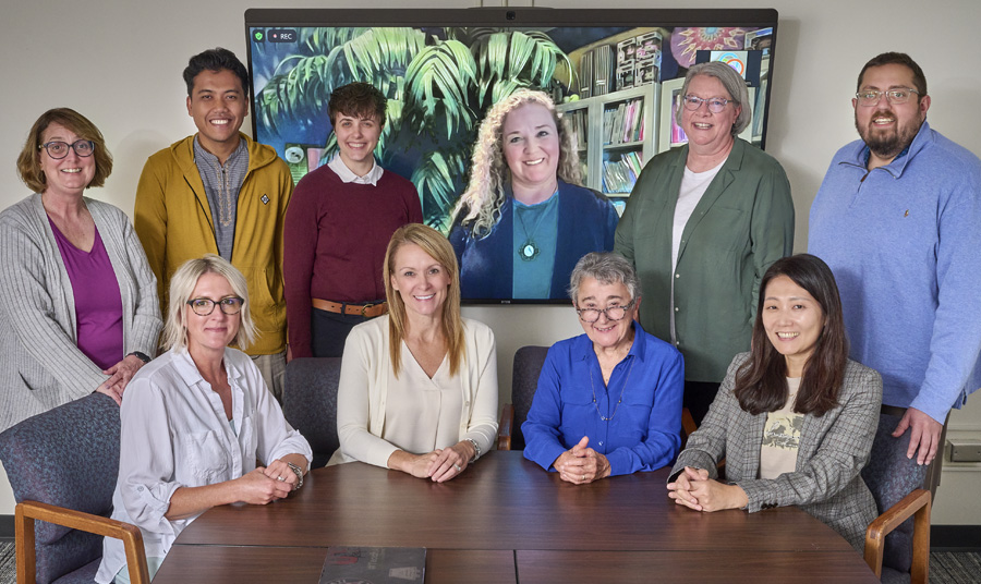 The Lab-Aids publishing staff and Connected Mathematics Project staff partner at Wells Hall on the Campus of MSU to publish ConnectedMathematics4. Front row (left to right): Elizabeth “Billie” Lozen, Lisa Kelp, Elizabeth “Betty” Difanis Phillips, and Sunyoung Park. Back Row (left to right): Kathy Dole, Ahmad Kohar, Taren Going, Denise Botelho (via Zoom), Yvonne Slanger-Grant, and Alden “A.J.” Edson